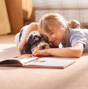 Image of girl reading to dog