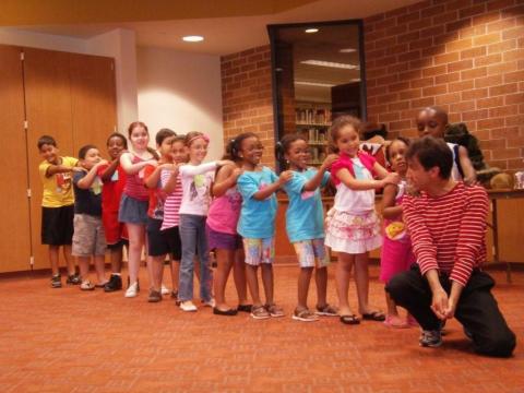 man acting silly with happy kids